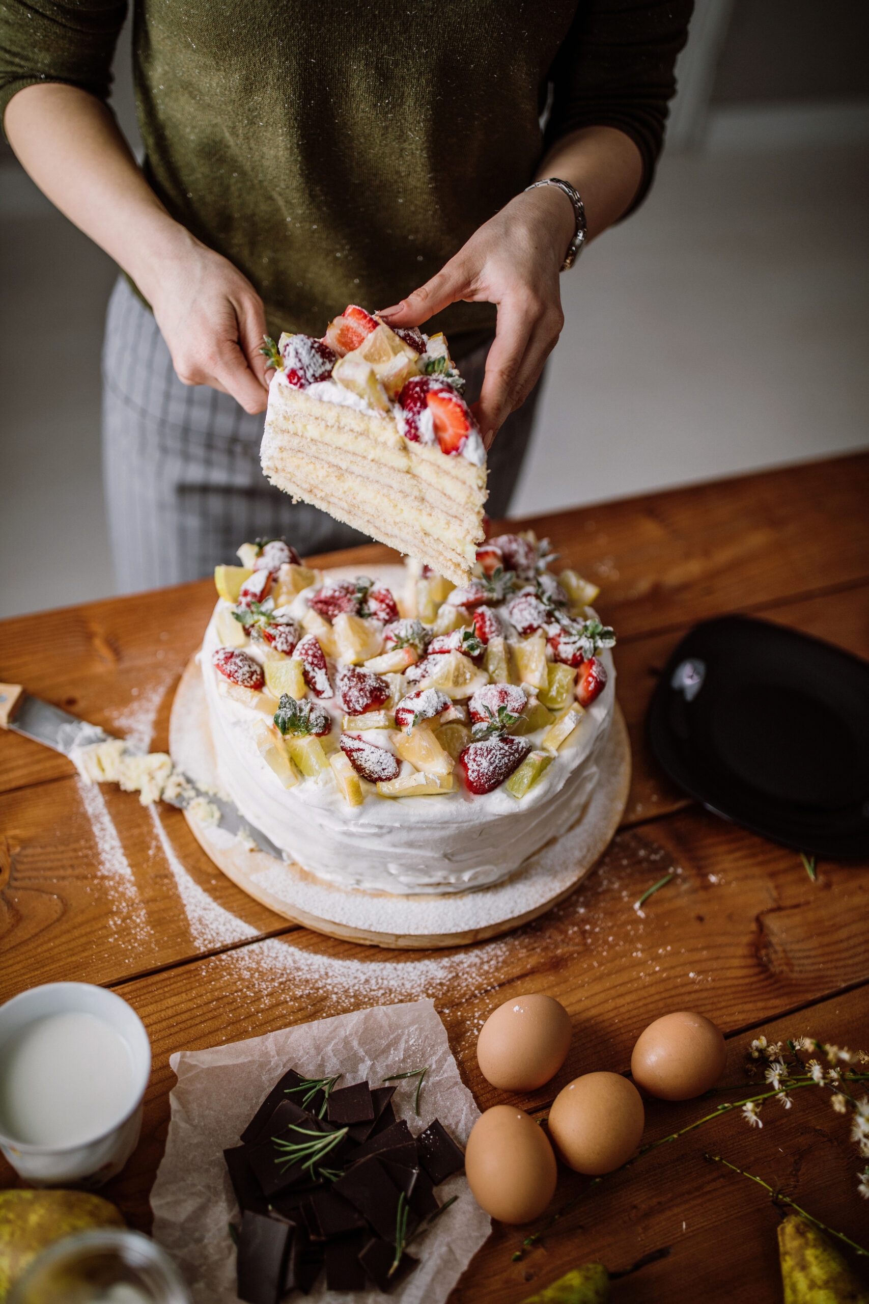 Woman cut a piece of cake for the birthday celebrant